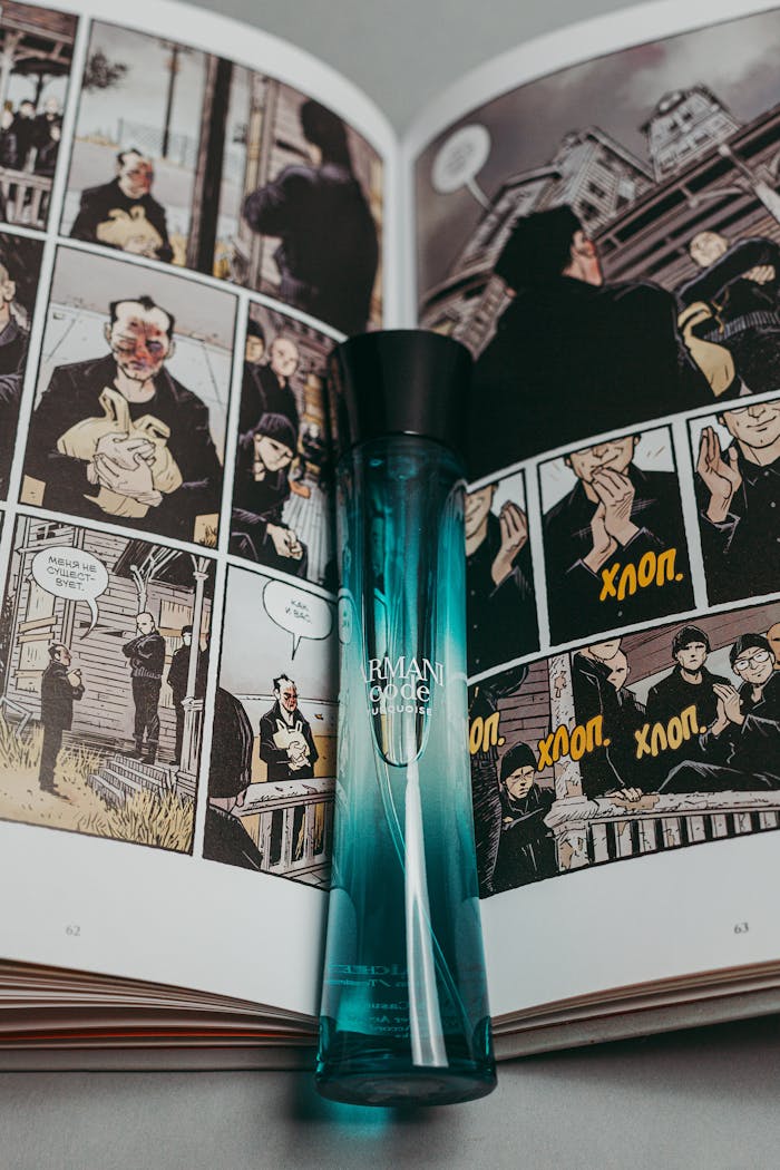 Elegant luxury perfume bottle on an open comic book with artistic illustrations.